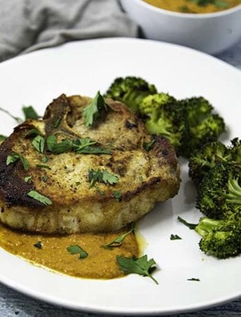 Seared Pork Chops with Broccoli on White Plate