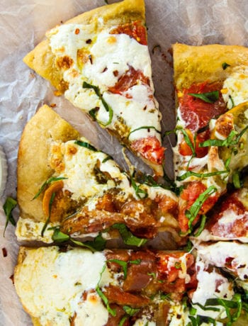 Tomato Burrata and Bail pizza cut into slices