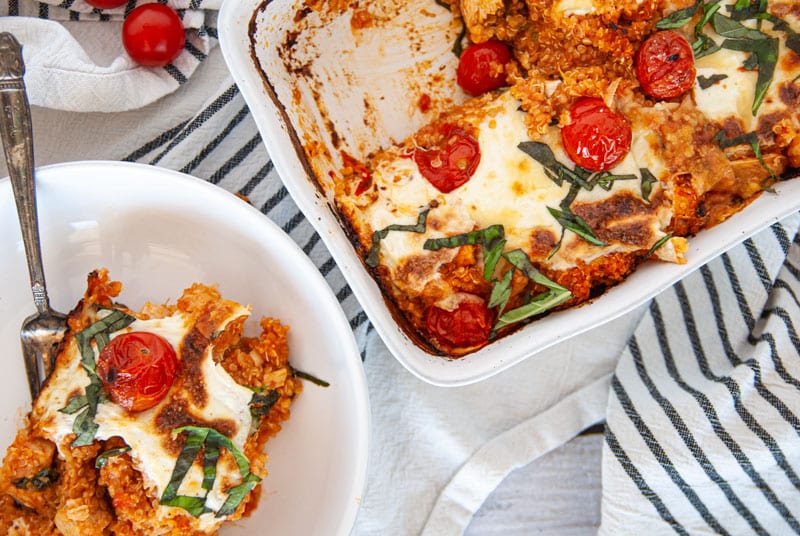 Caprese Casserole bowl with piece missing out of casserole dish