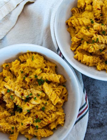 Two Bowls of Pumpkin Mac and cheese in white bowls