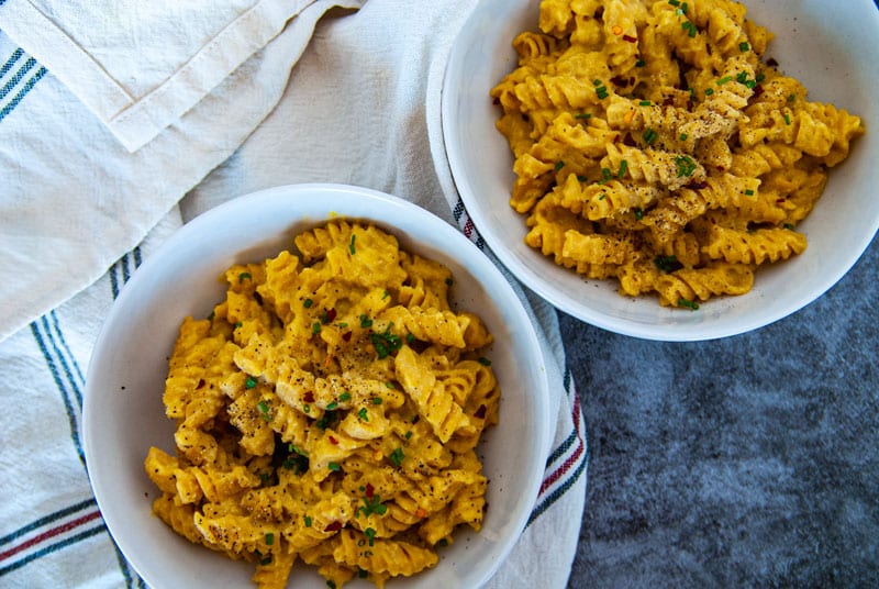 Two Bowls of Pumpkin Mac and cheese in white bowls