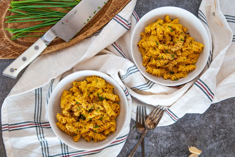 Two Bowls of Pumpkin Mac and cheese in white bowls