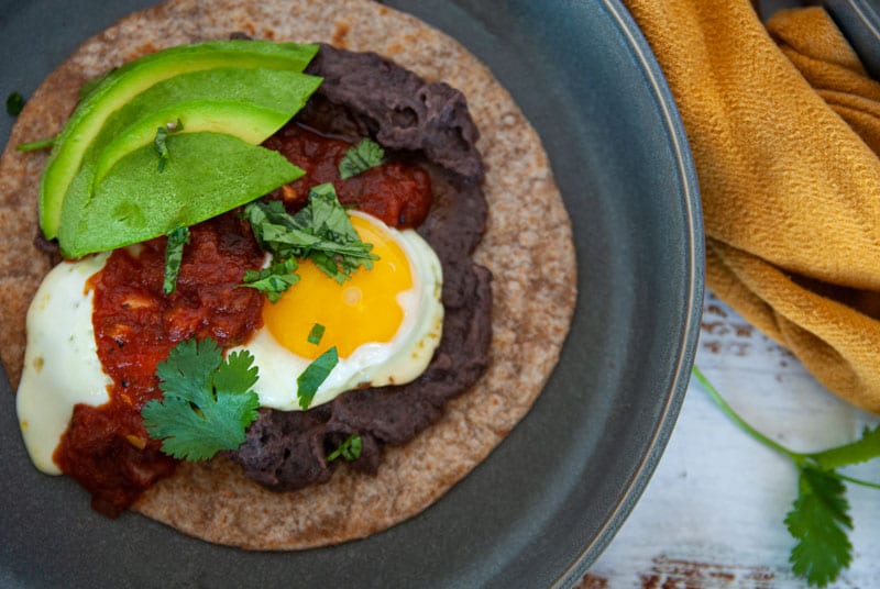 Close up shot of Easy Huevos Rancheros Made with Black Re-fried Beans