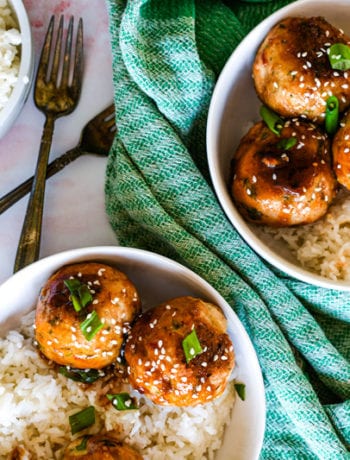 Asian Chicken Meatballs over Rice with Green Onion and Sesame Seeds