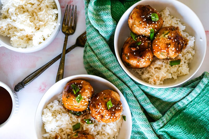 Asian Chicken Meatballs over Rice with Green Onion and Sesame Seeds