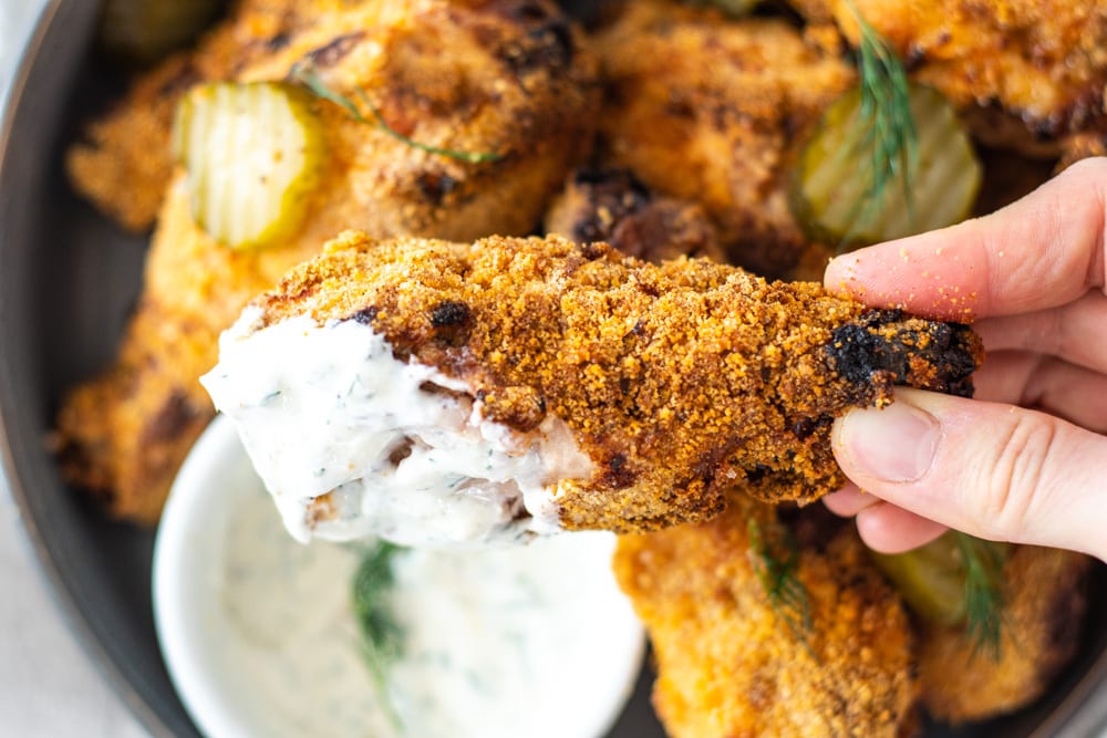 Picking up an airfried pickle chicken Drumstick