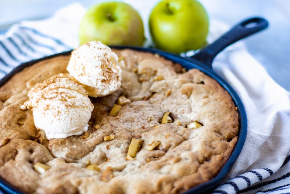 Picture of Apple Cinnamon Blondie Bake with two scoops of Vanilla Ice Cream and two apples in back