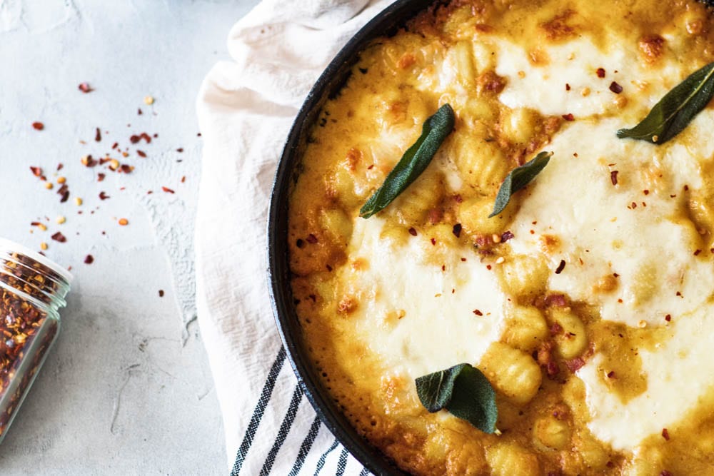 Baked Gnocchi with Pumpkin Cream Sauce right out of the oven in a cast iron skillet