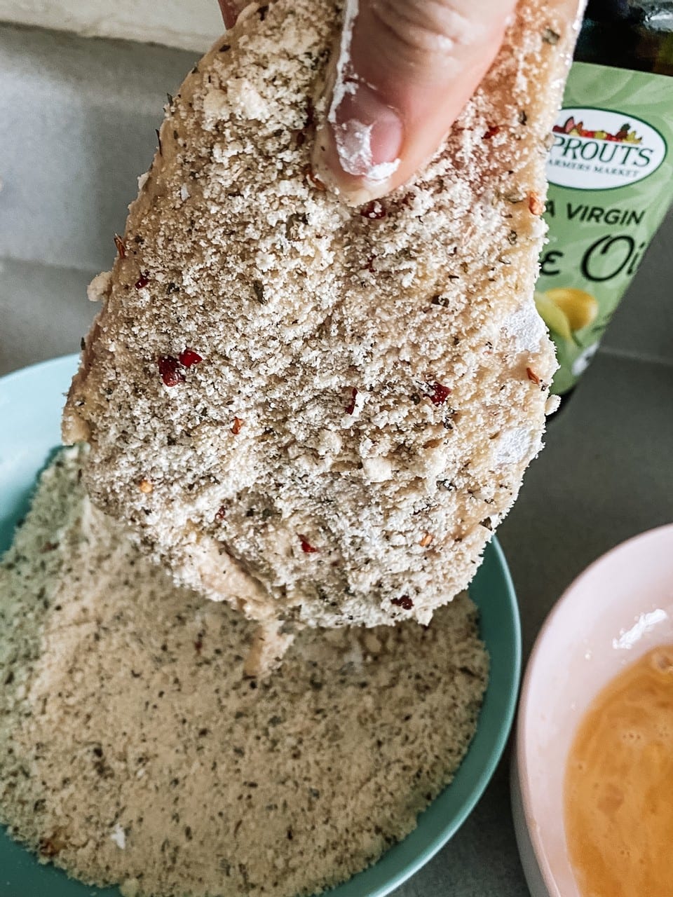 Paleo Breaded chicken last step dredge in Almond flour