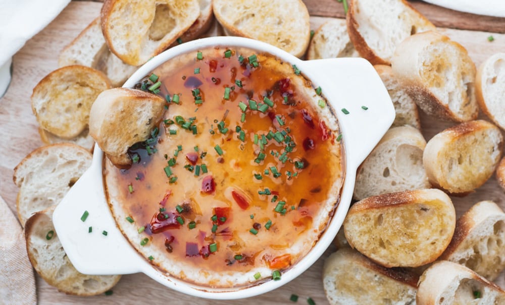 Close up of Baked Goat Cheese dip and toast points around